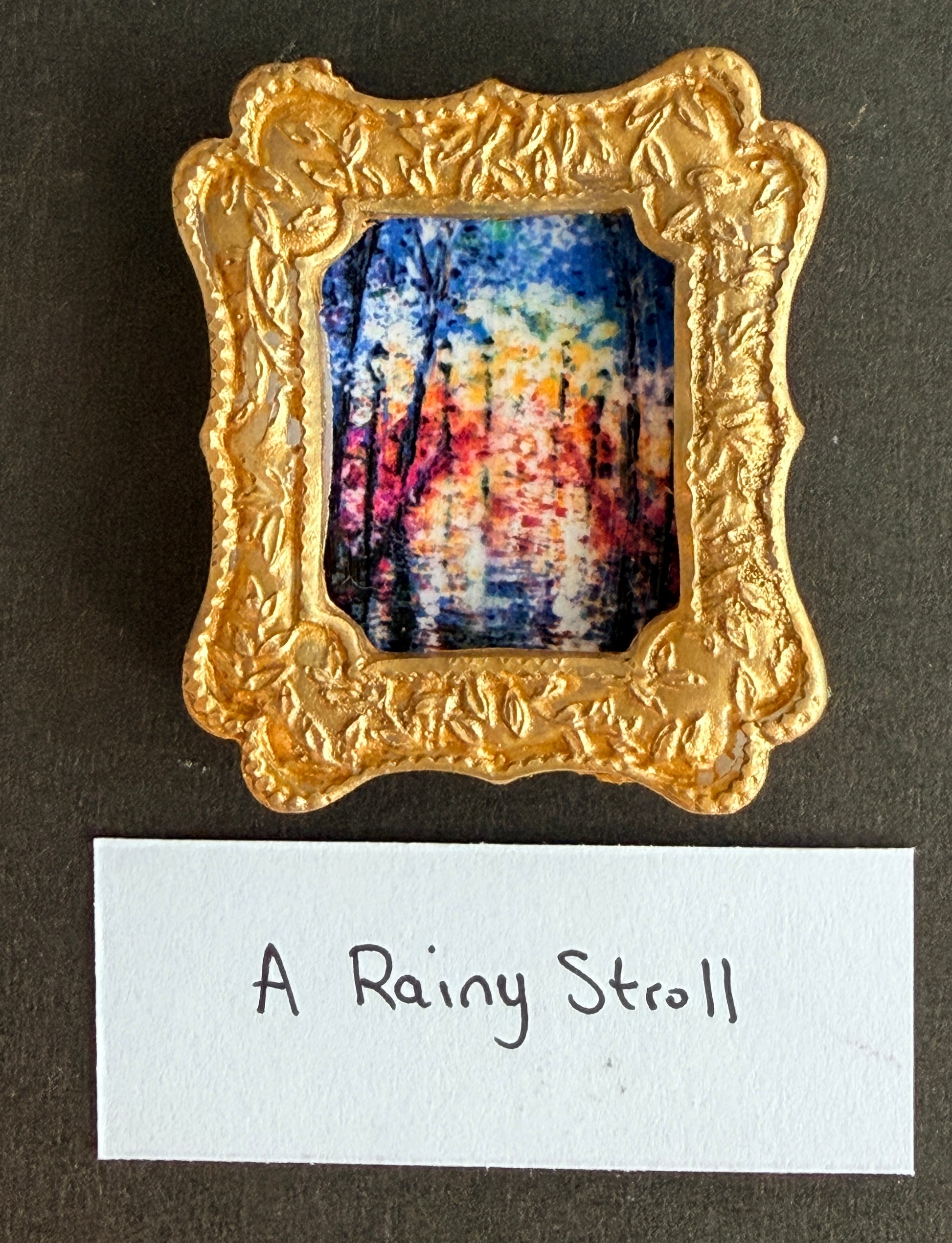 A vibrant colorful abstract rainy walk in a gold frame fridge magnet with the words A Rainy Stroll below it
