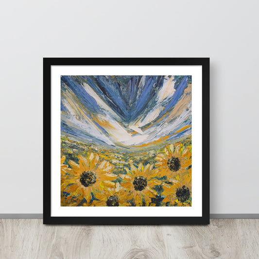 An abstract landscape sunflower field art print in a black frame leaned up against a wall