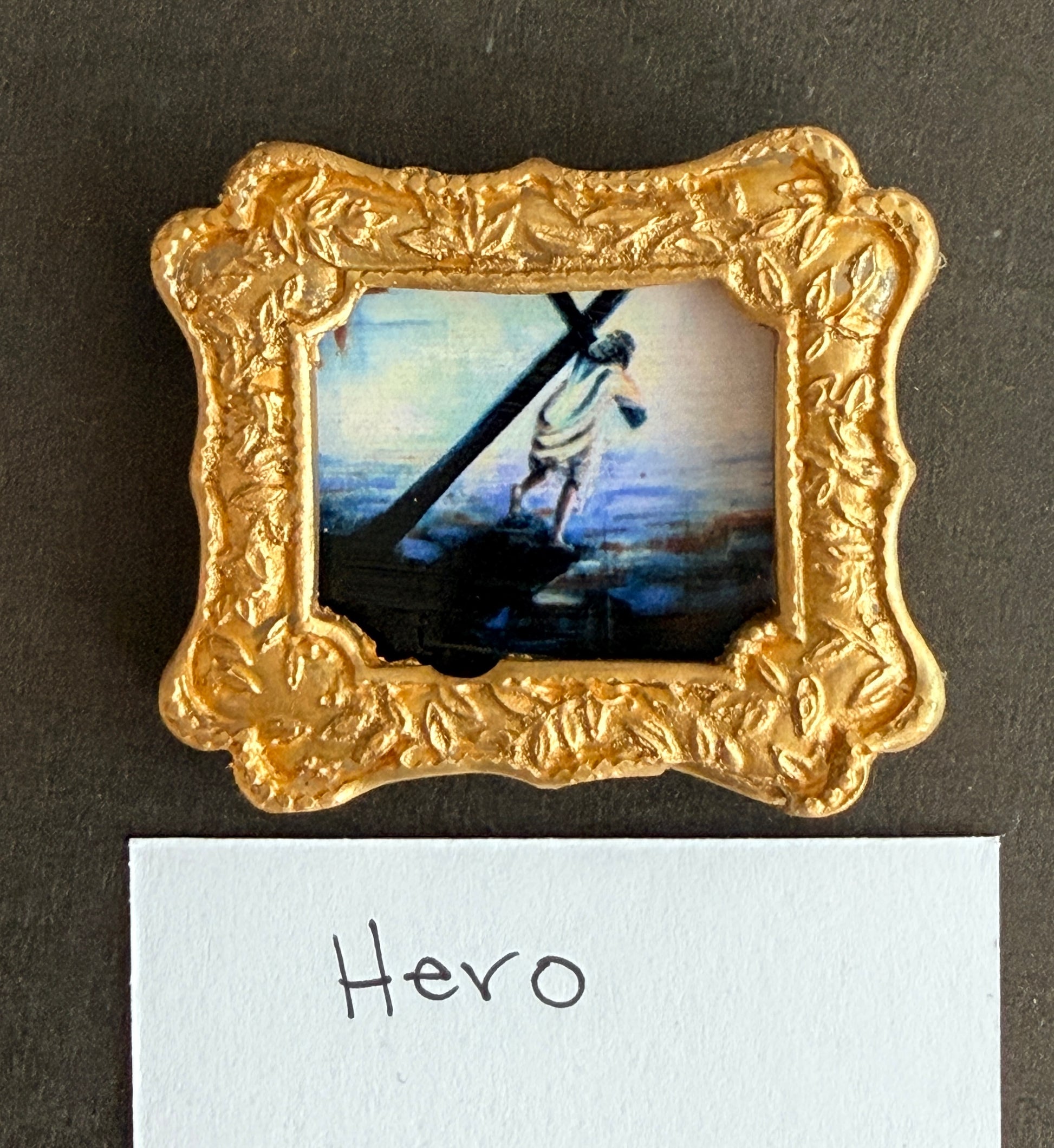 A photo of jesus in a small gold frame