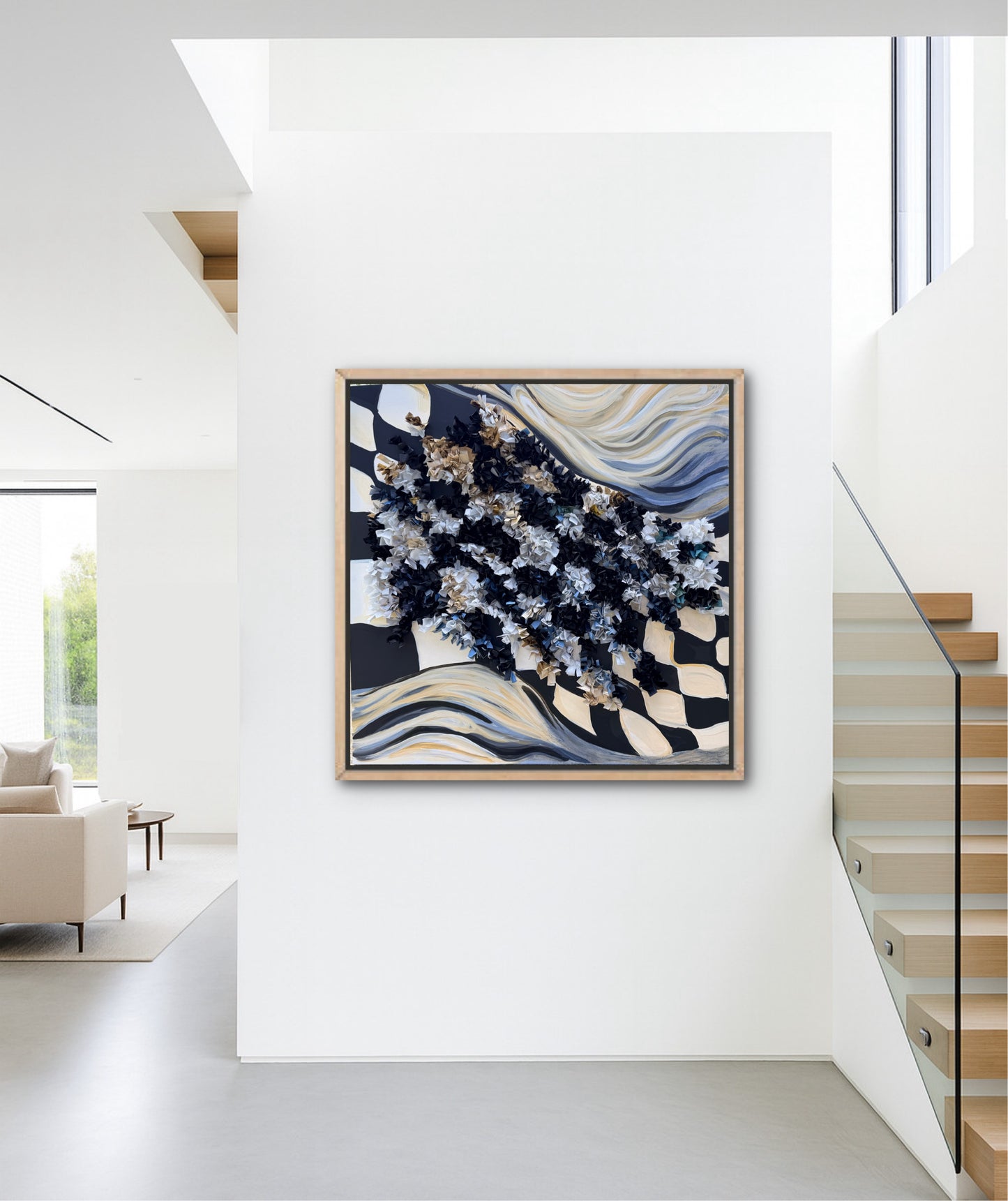 Abstract checkered black and white art piece in a modern interior setting with a staircase and sofa.