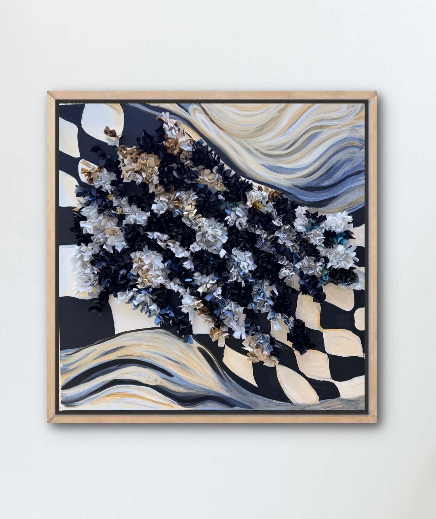 a heavily textured black and white checkered flag abstract art piece hangs on a white wall 