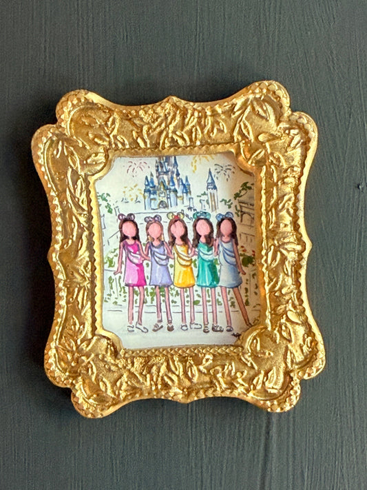 Decorative gold frame with a small illustration of cartoon drawings of women in front of a disney castle