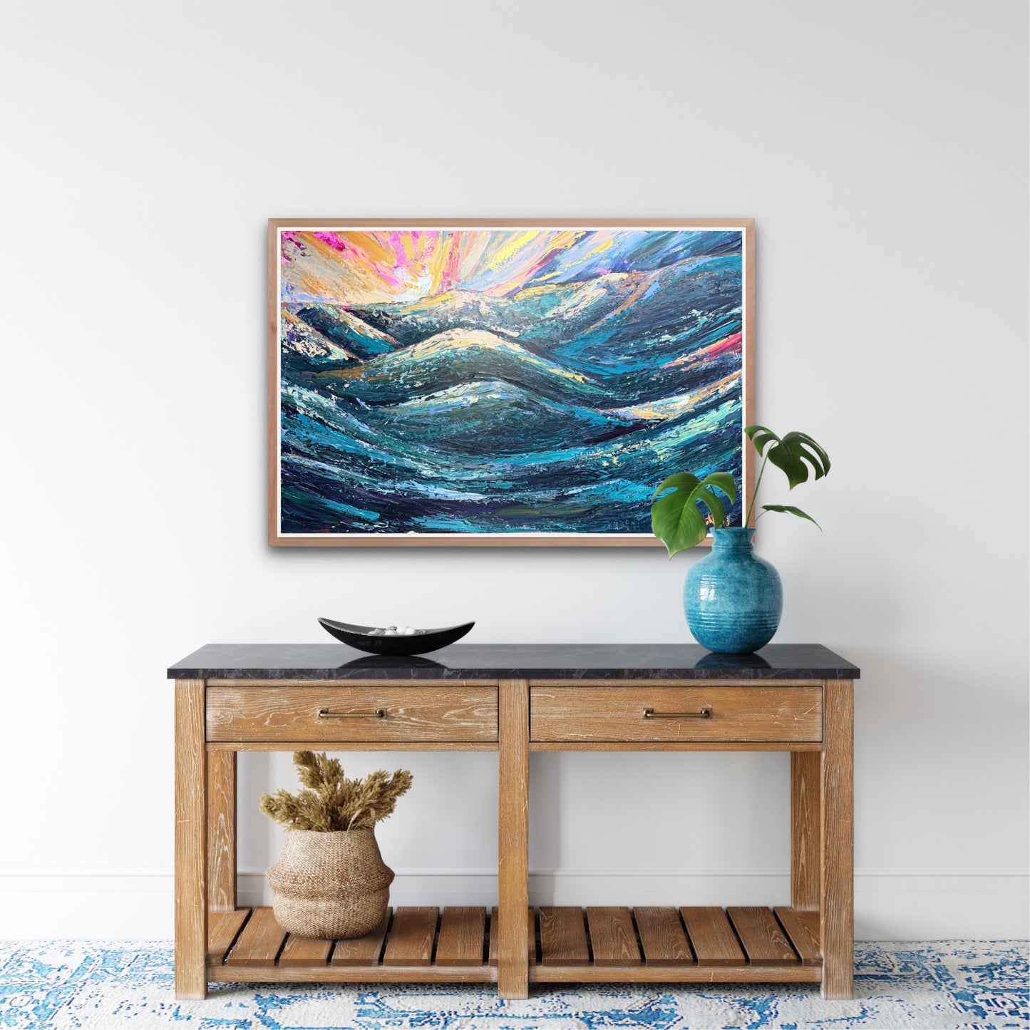 a colorful abstract sunset painting is hung on a white wall over a decorated console table