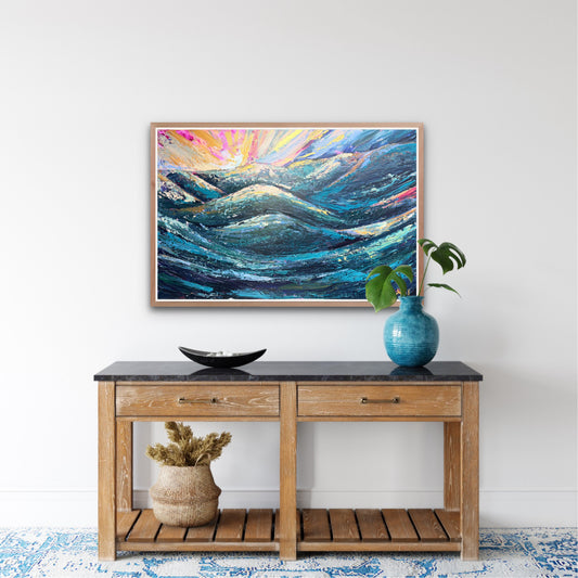 a colorful abstract sunset painting is hung on a white wall over a decorated console table