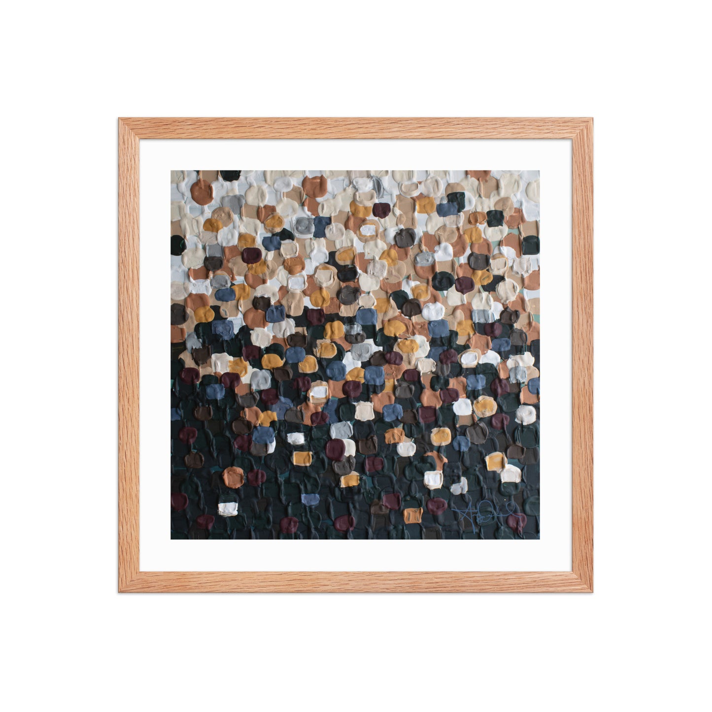 An abstract pointillism piece of framed art in a red oak frame on a white wall